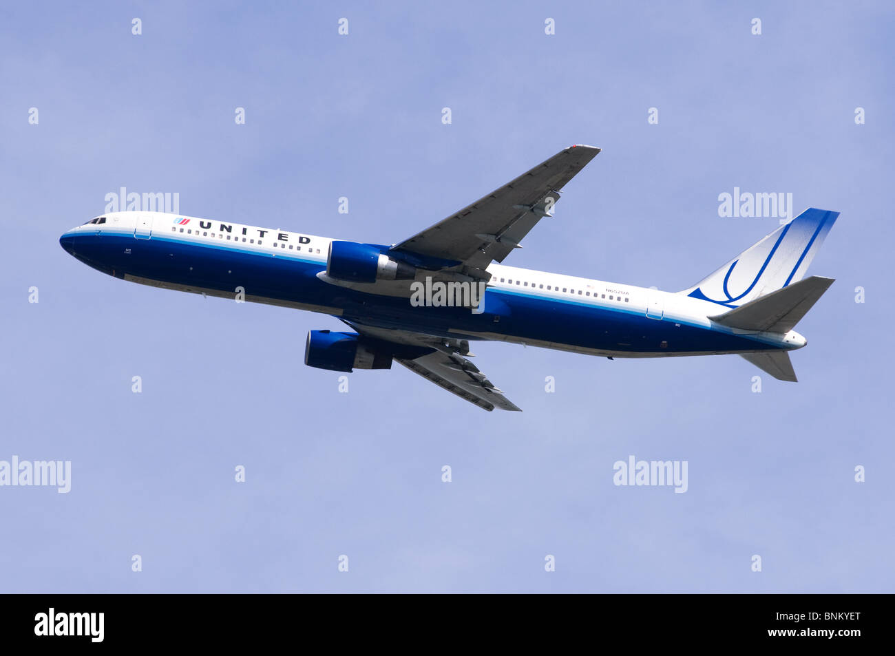 Boeing 777 operated by United Airlines climbing out from take off at London Heathrow Airport, UK. Stock Photo
