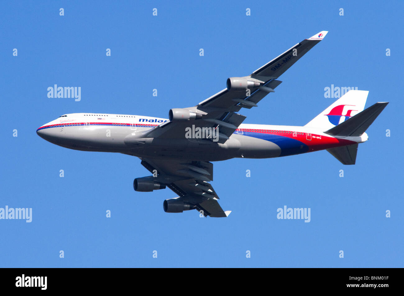 Boeing 747 operated by Malaysia Airlines climbing out after take off from London Heathrow Airport, UK. Stock Photo