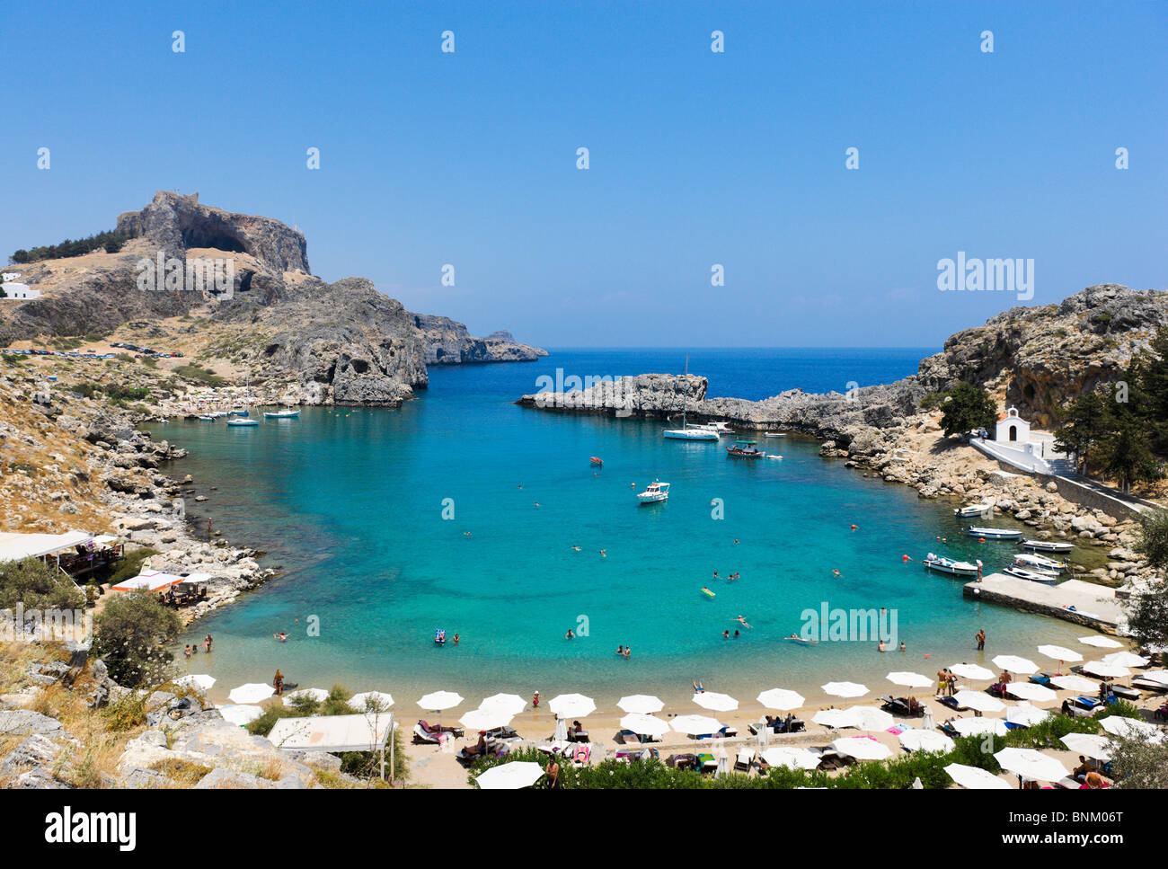 St Paul's Bay Beach with the Acropolis behind, Lindos, Rhodes, Greece Stock Photo
