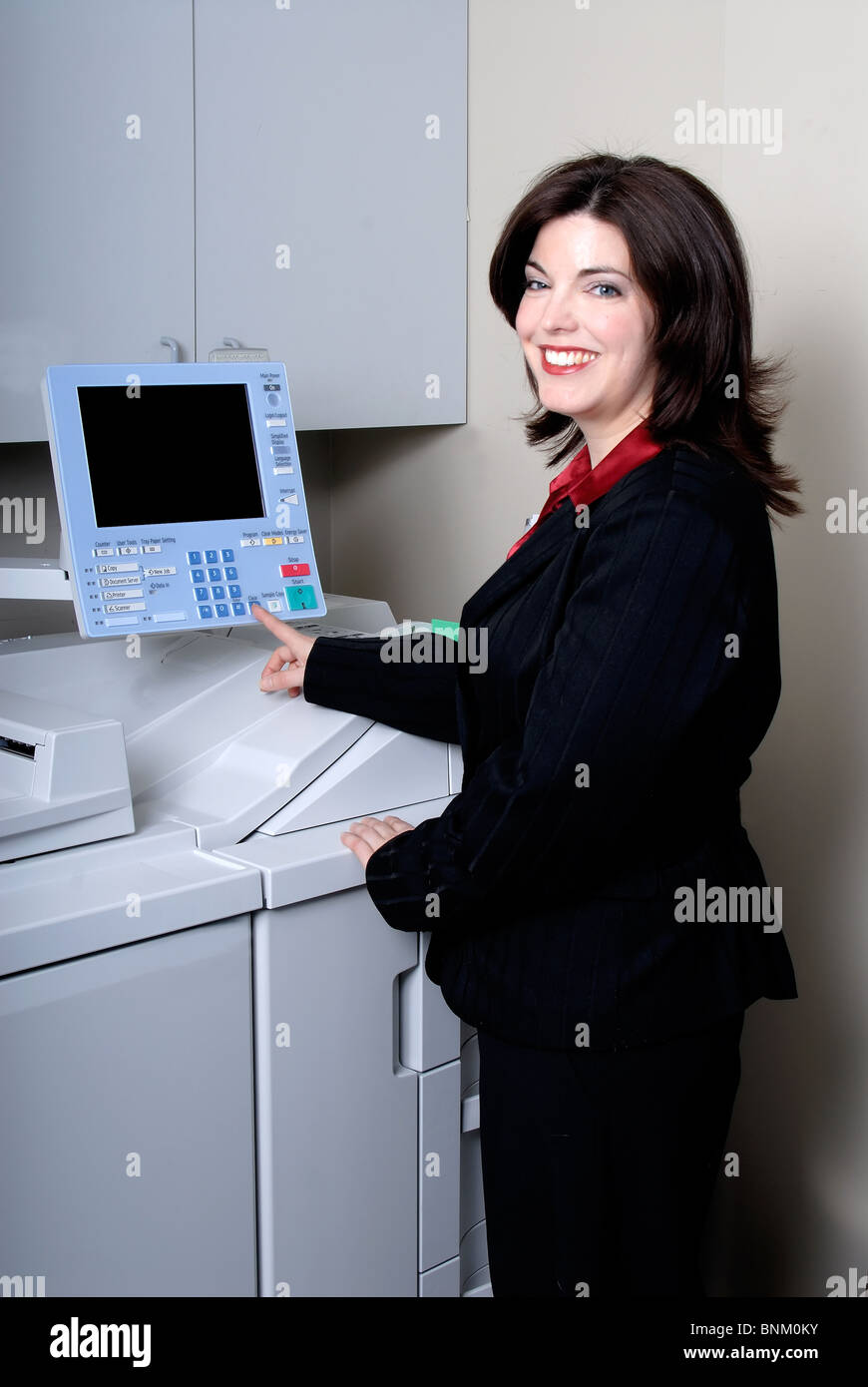 Attractive Young Woman Photocopying In The Office Stock Photo