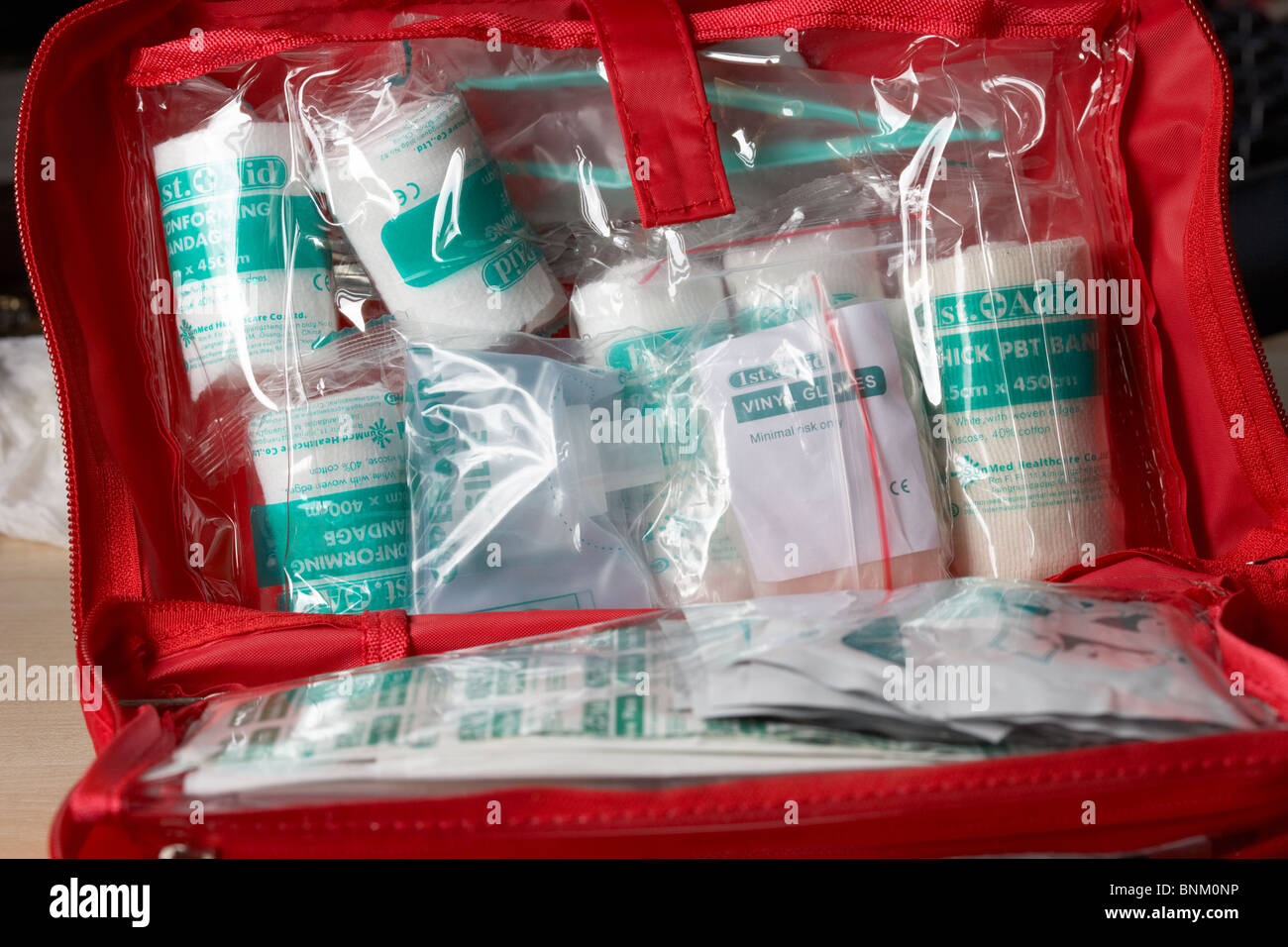 bandages and various contents of a home small office first aid kit Stock Photo