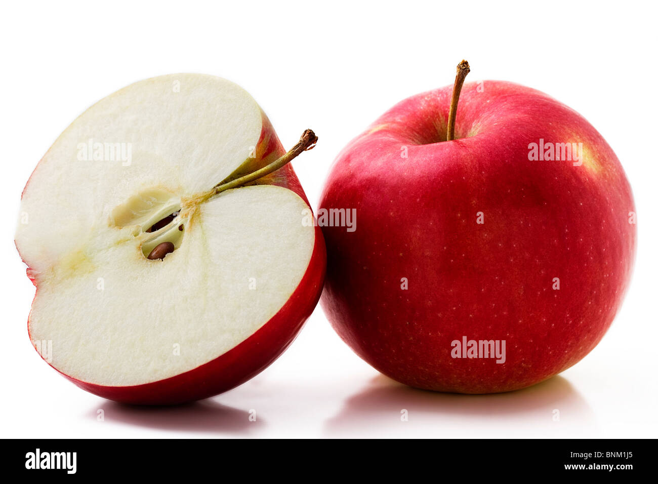one red apple and a half isolated on white background Stock Photo