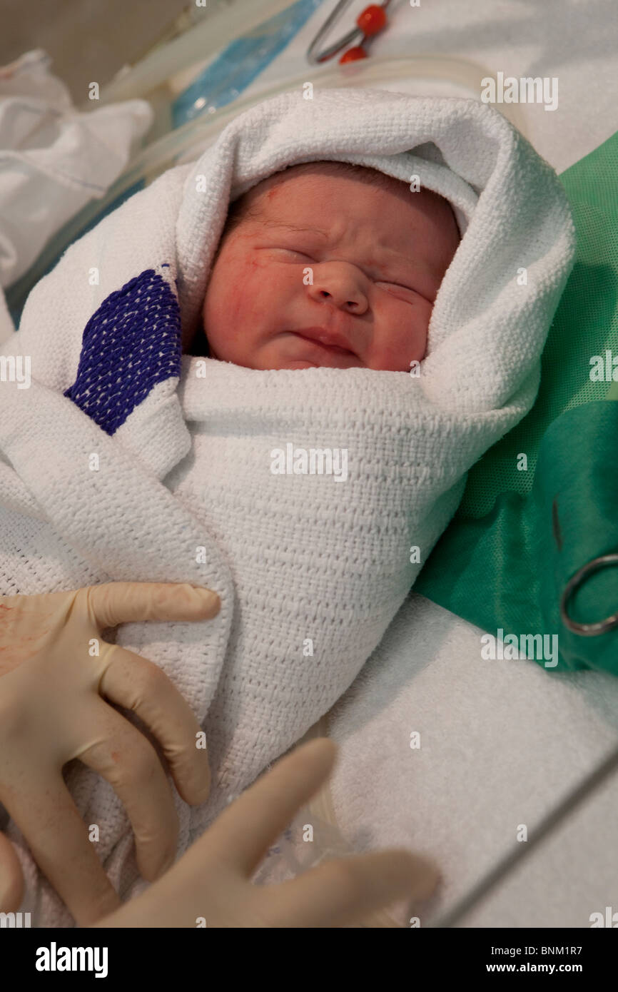 Newborn baby being swaddled Stock Photo Alamy