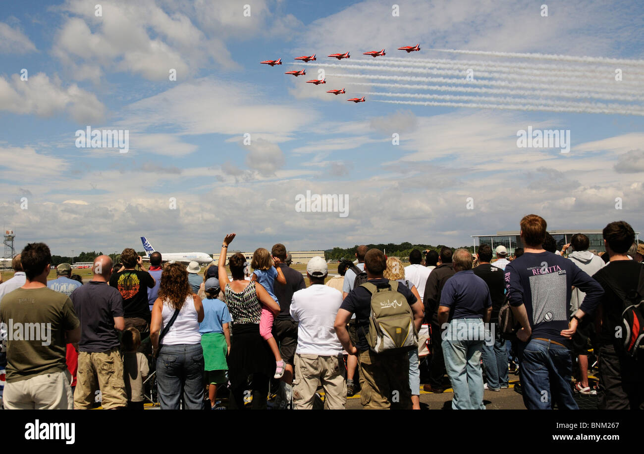 Red Arrows RAF formation flying team being watched by spectators at the Farnborough Air Show in southern England UK Stock Photo