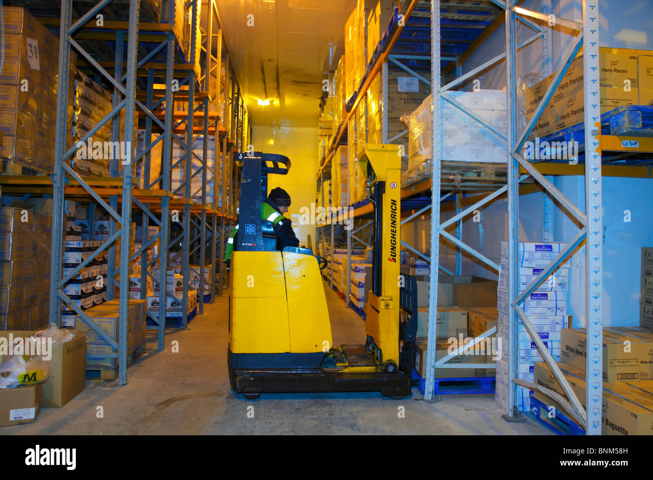 Fork Lift Truck operating in a frozen goods warehouse. Stock Photo