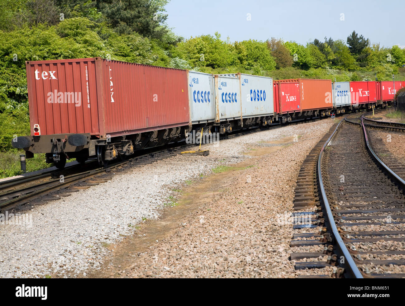 Railway freight train carrying containers rail lines rear view Stock Photo Alamy