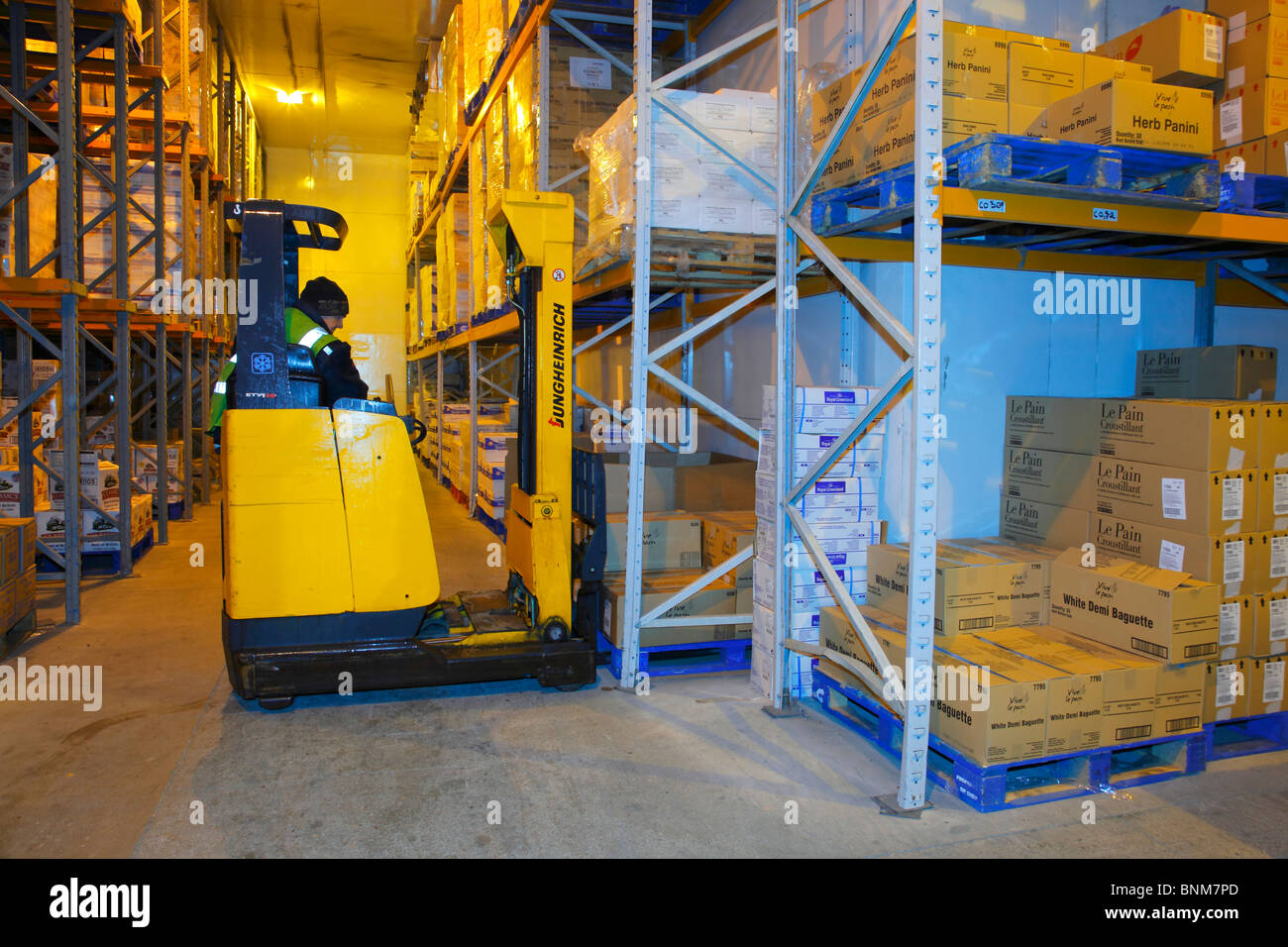 Fork Lift Truck operating in a frozen goods warehouse. Stock Photo