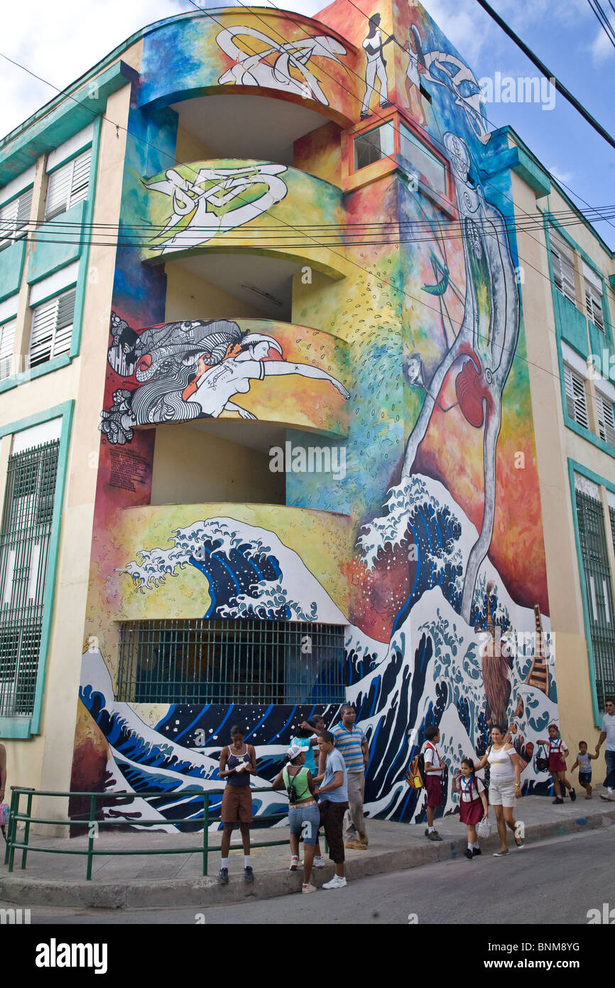 A mural with passing school children in Santiago de Cuba, Cuba Stock Photo