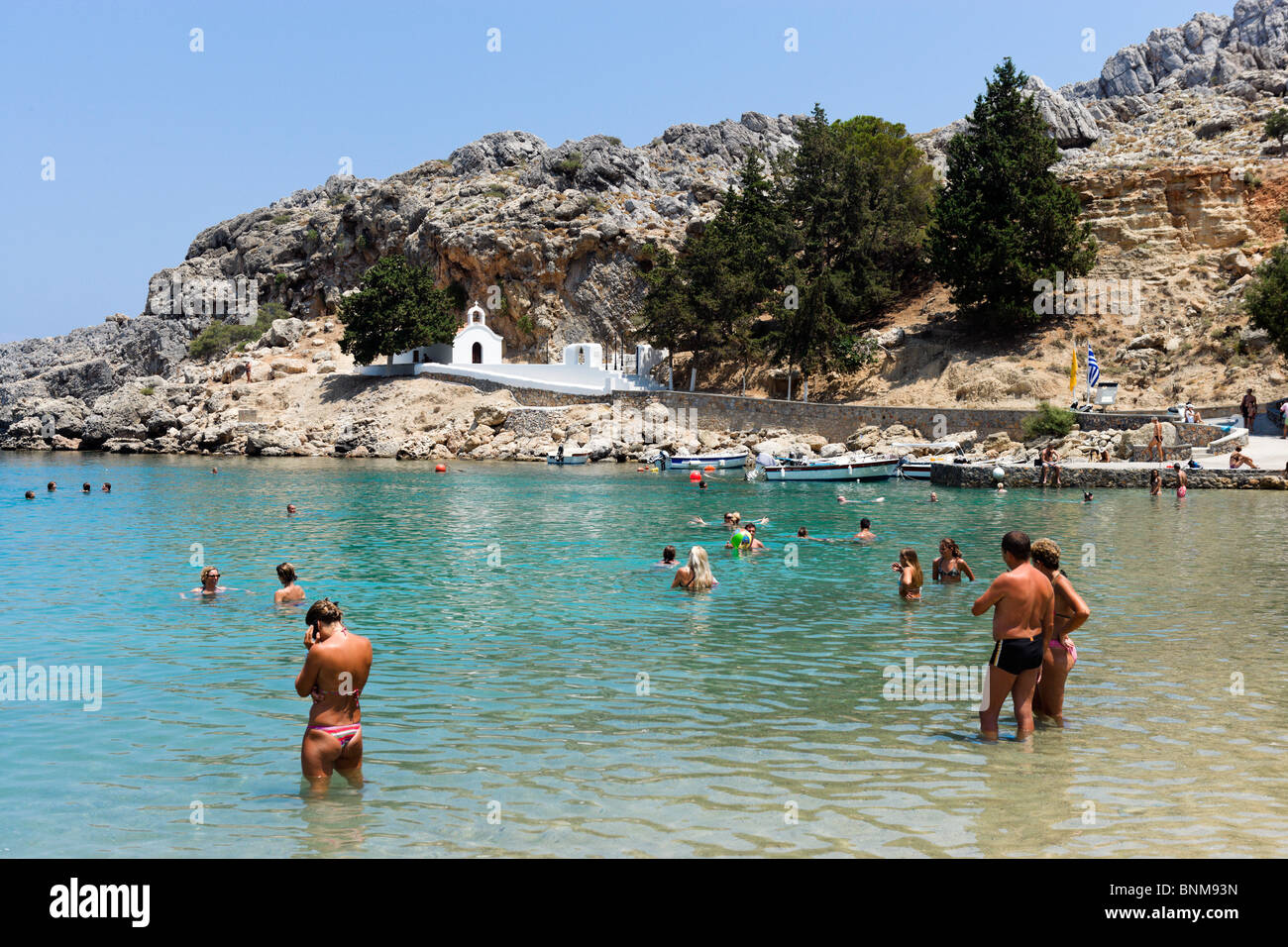 Whitewashed chapel on St Paul's Bay Beach, Lindos, Rhodes, Greece Stock Photo