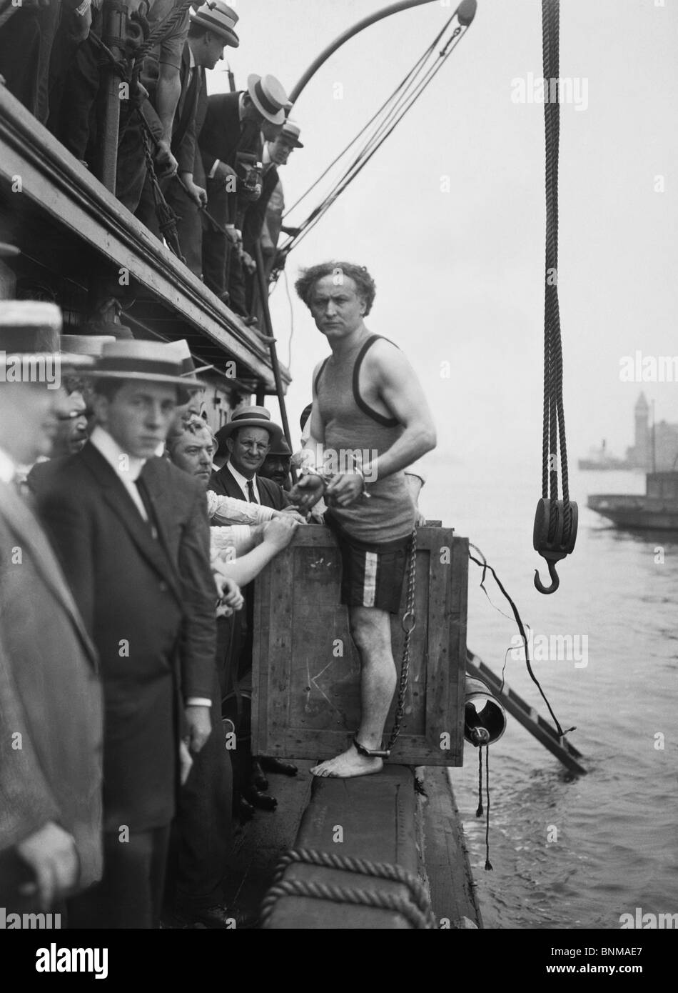 Escapologist Harry Houdini (1874 - 1926) preparing to perform his famous 'overboard box escape' for the first time in July 1912. Stock Photo