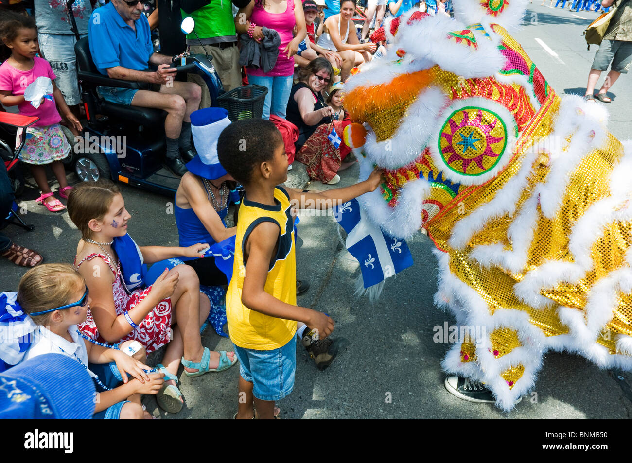 Chinese community celebrating St Jean Baptiste day in Vibrant multicultural city of Montreal Canada Stock Photo