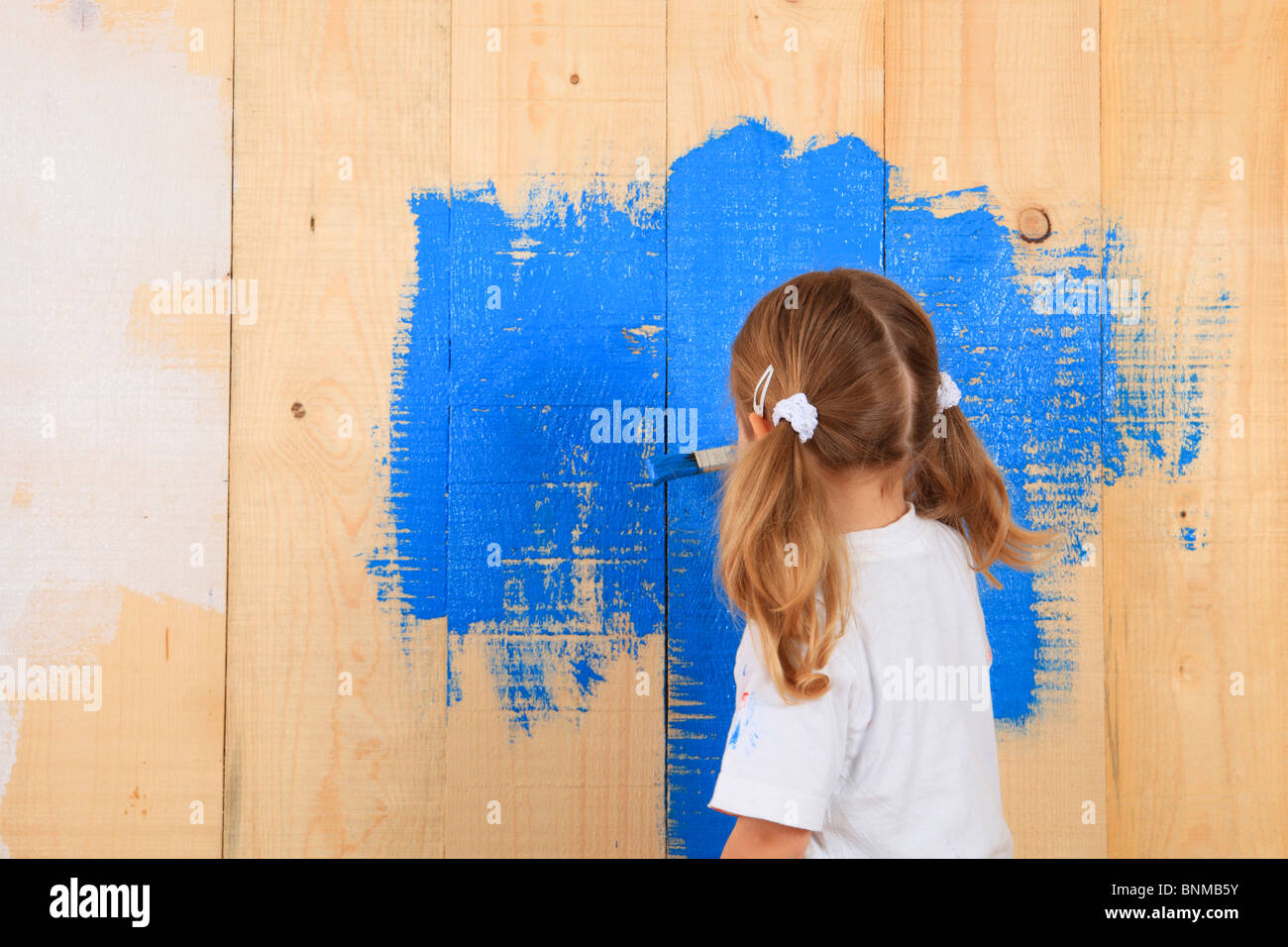 Girls 3 years old 3-year-old board shelf boards shelves wooden wall color paintbrush spot of colour luck happiness wood wooden Stock Photo