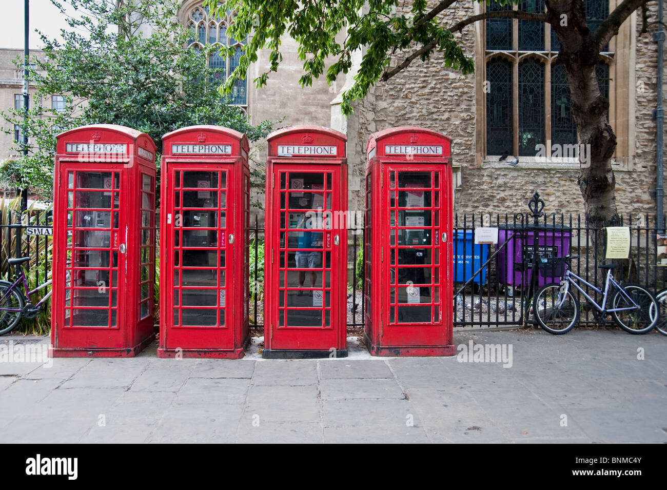 Four traditional red telephone boxes in Cambridge England Stock Photo