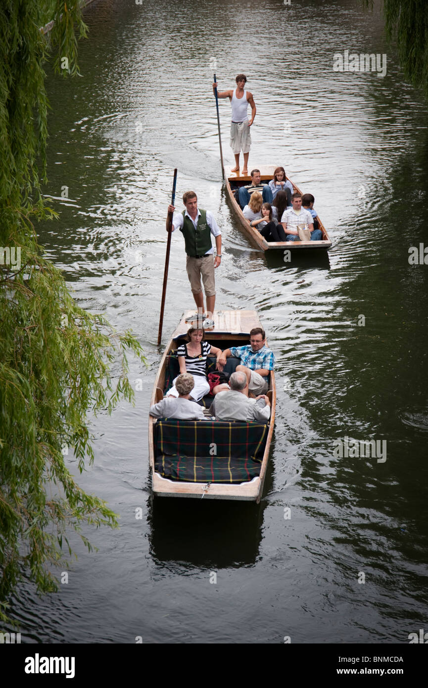 Punting on the river Cam, Cambridge. Tourists on chauffered punt tours on summer day Stock Photo