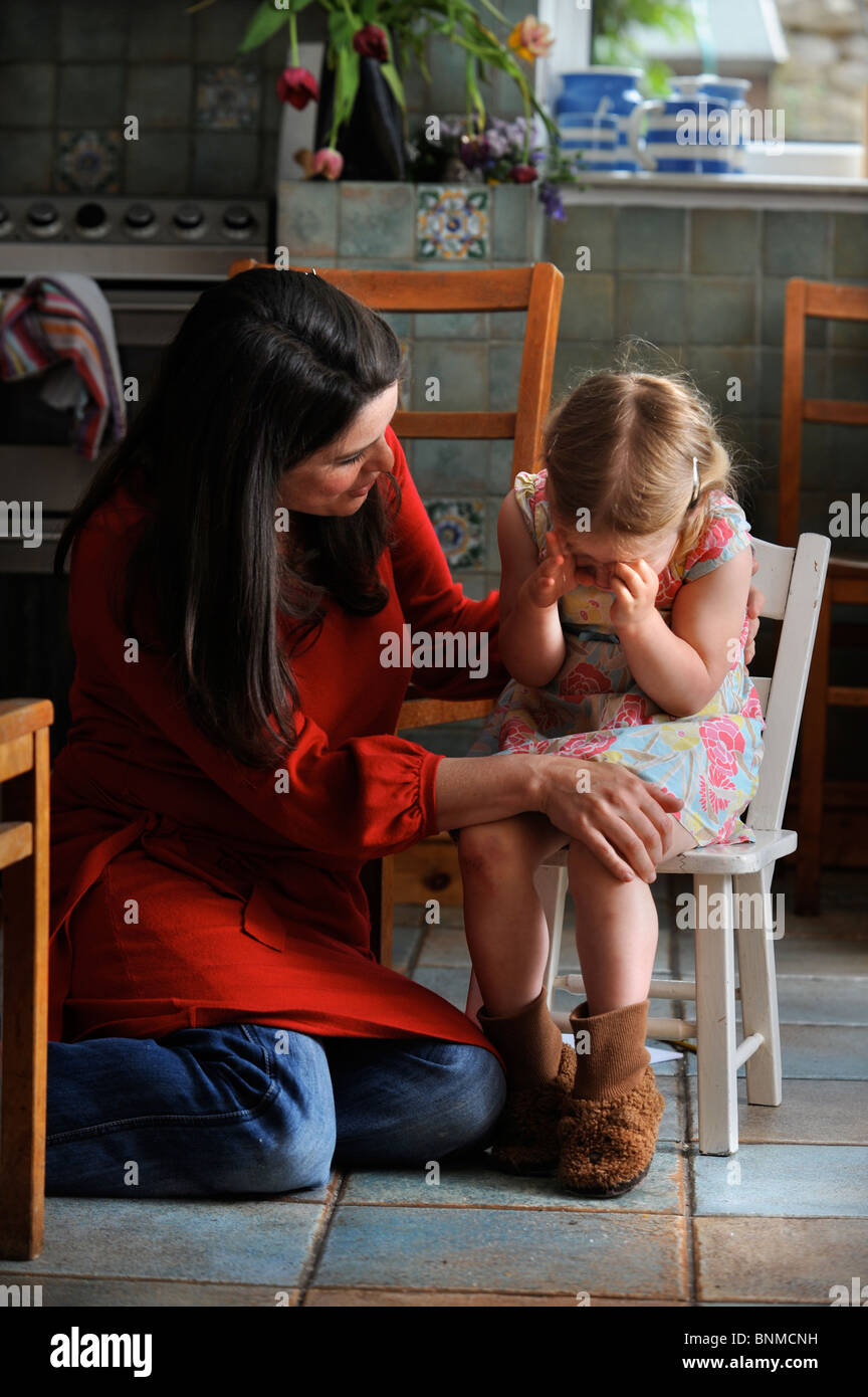 A three year old girl being comforted by her mother UK Stock Photo - Alamy