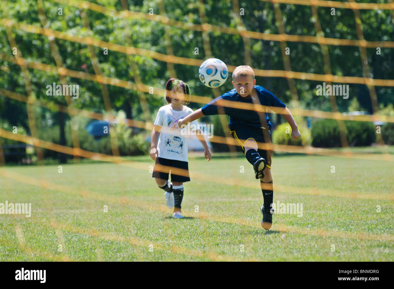 A Boy Kicks A Soccer Ball Into The Goal Net During Practice At Summer Soccer Camp In Tumwater Washington Stock Photo Alamy