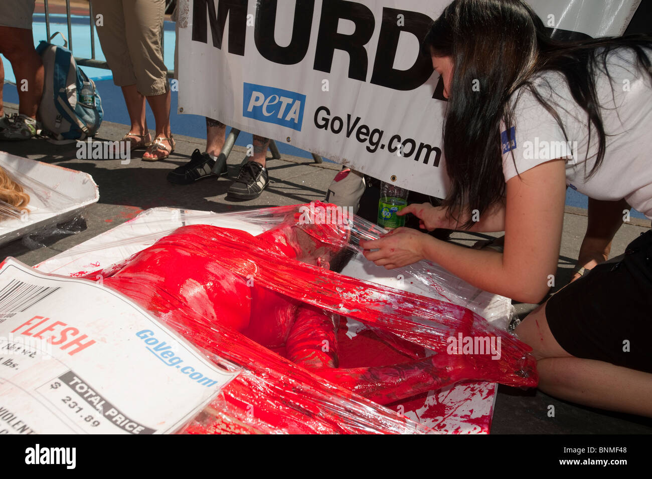 Activists from the animal rights group PETA protest the slaughter of animals in the production of meat in Times Square in NY Stock Photo