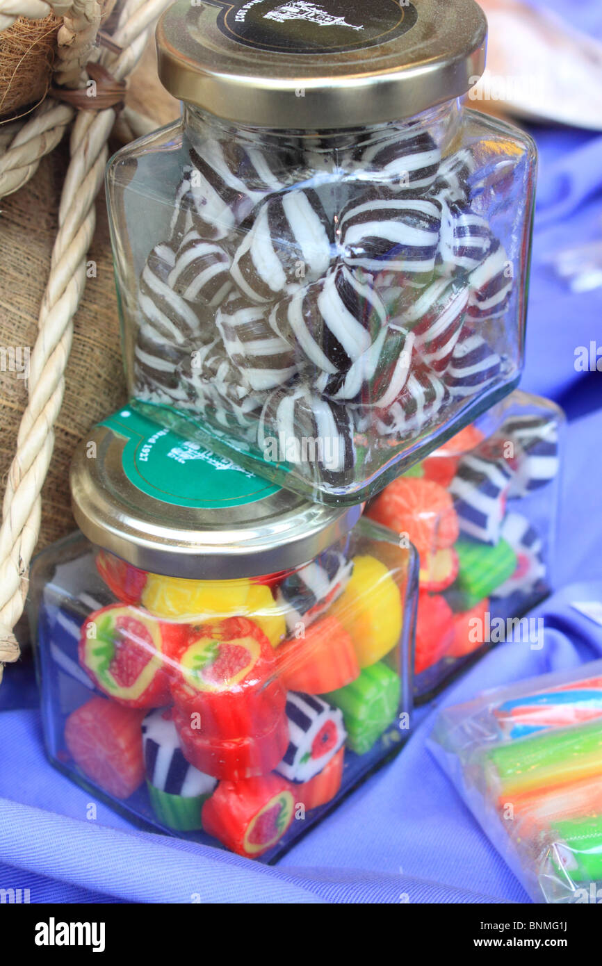traditional hard-boiled sweets in jars in a shop window in Keswick, Cumbria Stock Photo