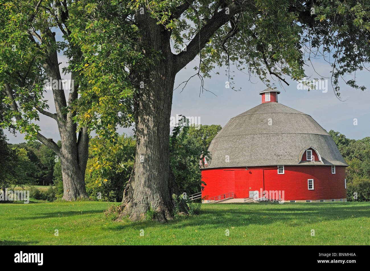 Barn building red round trees outdoors green meadow Johnson Sauk Trail State Park Illinois USA America North America Stock Photo