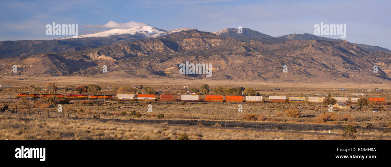 Landscape train traffic transport freight train mountains snow covered San Fidel New Mexico USA America North America Stock Photo