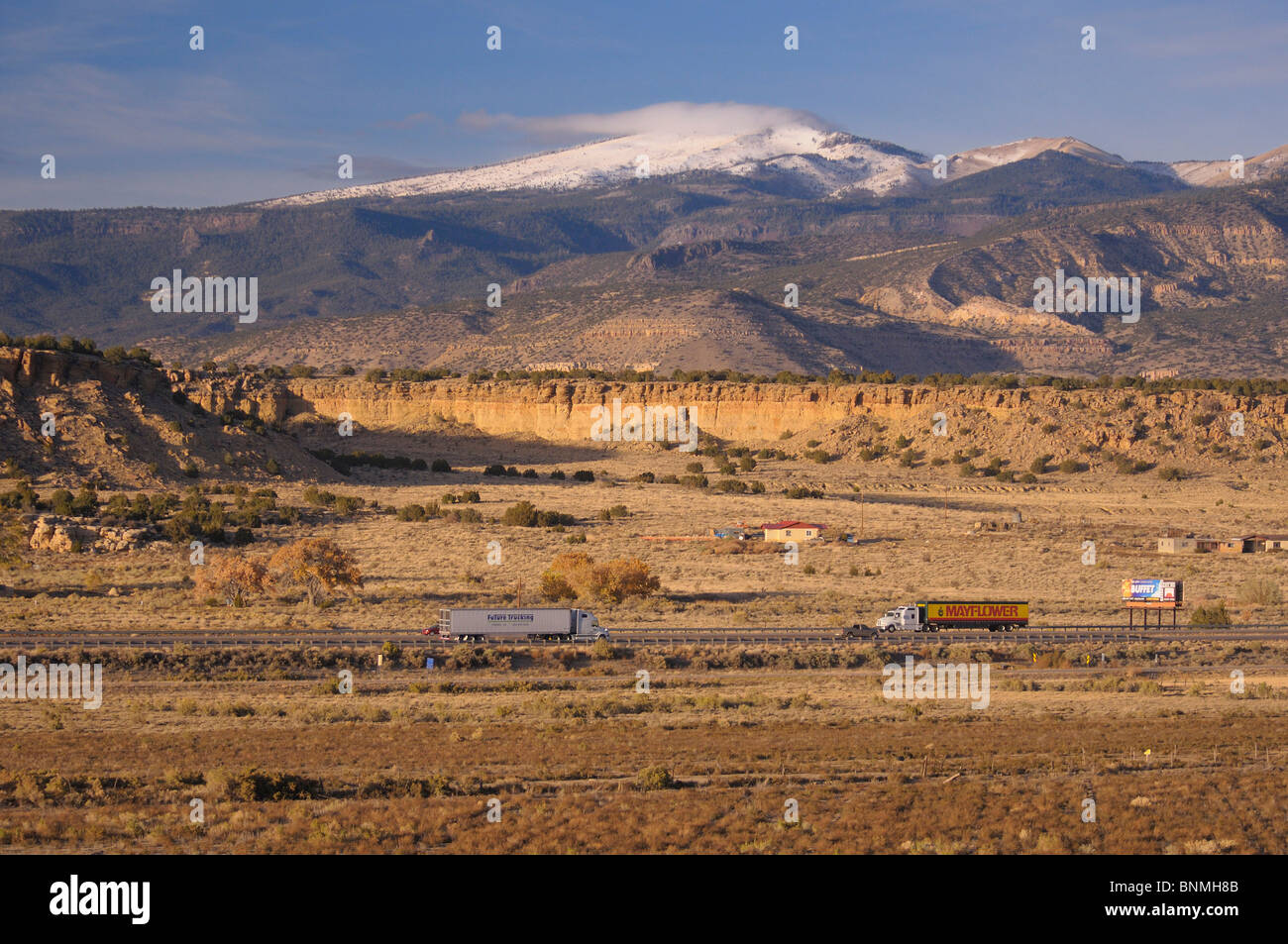 Interstate I-40 Interstate route traffic trucks Landscape transport mountains snow covered San Fidel New Mexico USA America Stock Photo