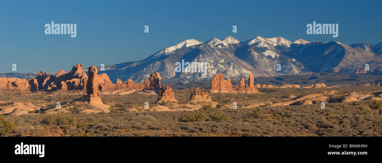 Rock Pinnacles La Sal Mountains mountains snow rock stone formation National Park landscape nature sky sunlight Arches National Stock Photo