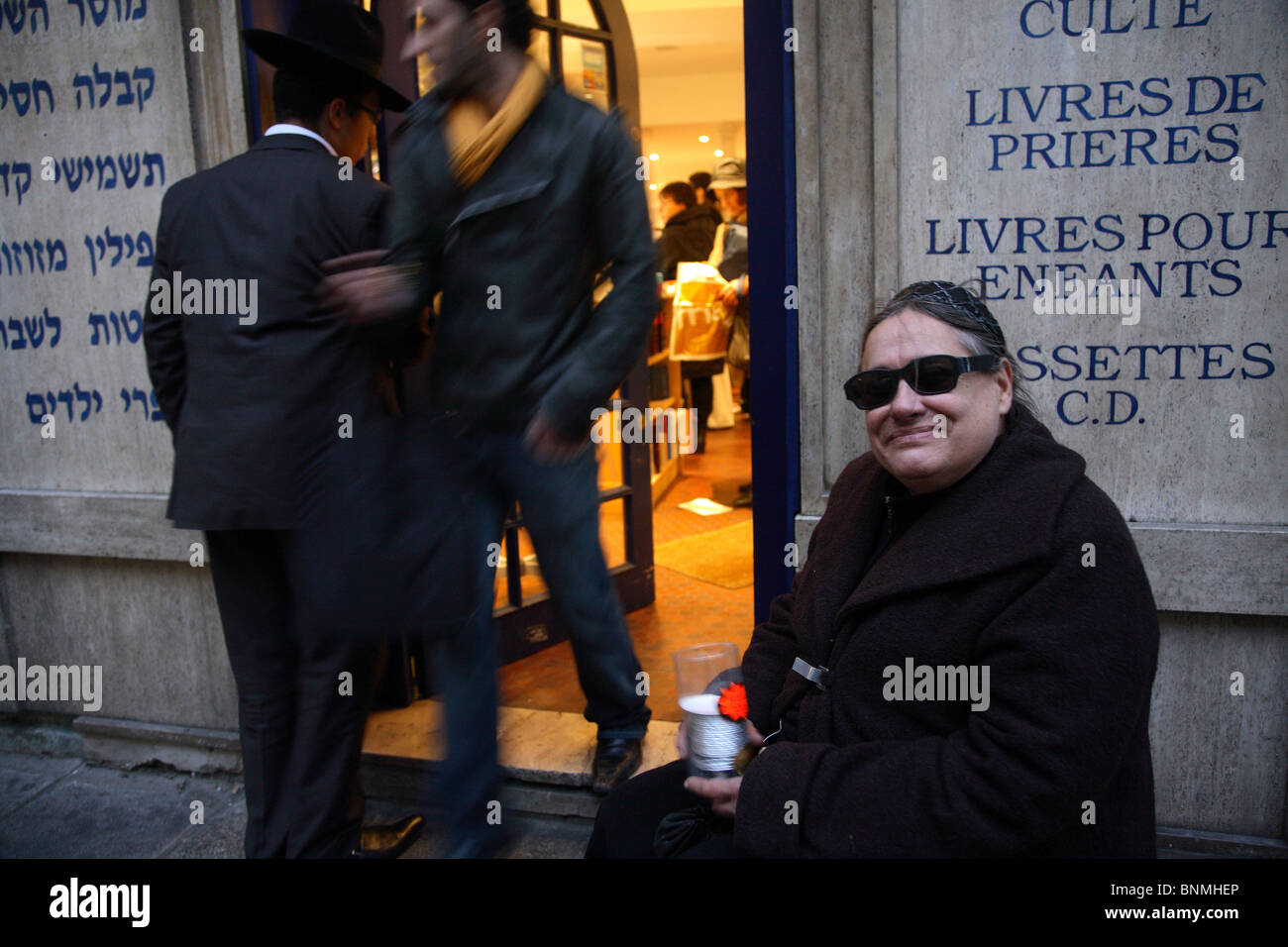 Woman collecting money for Hanukkah in front of a Jewish bookstore, Paris, France Stock Photo
