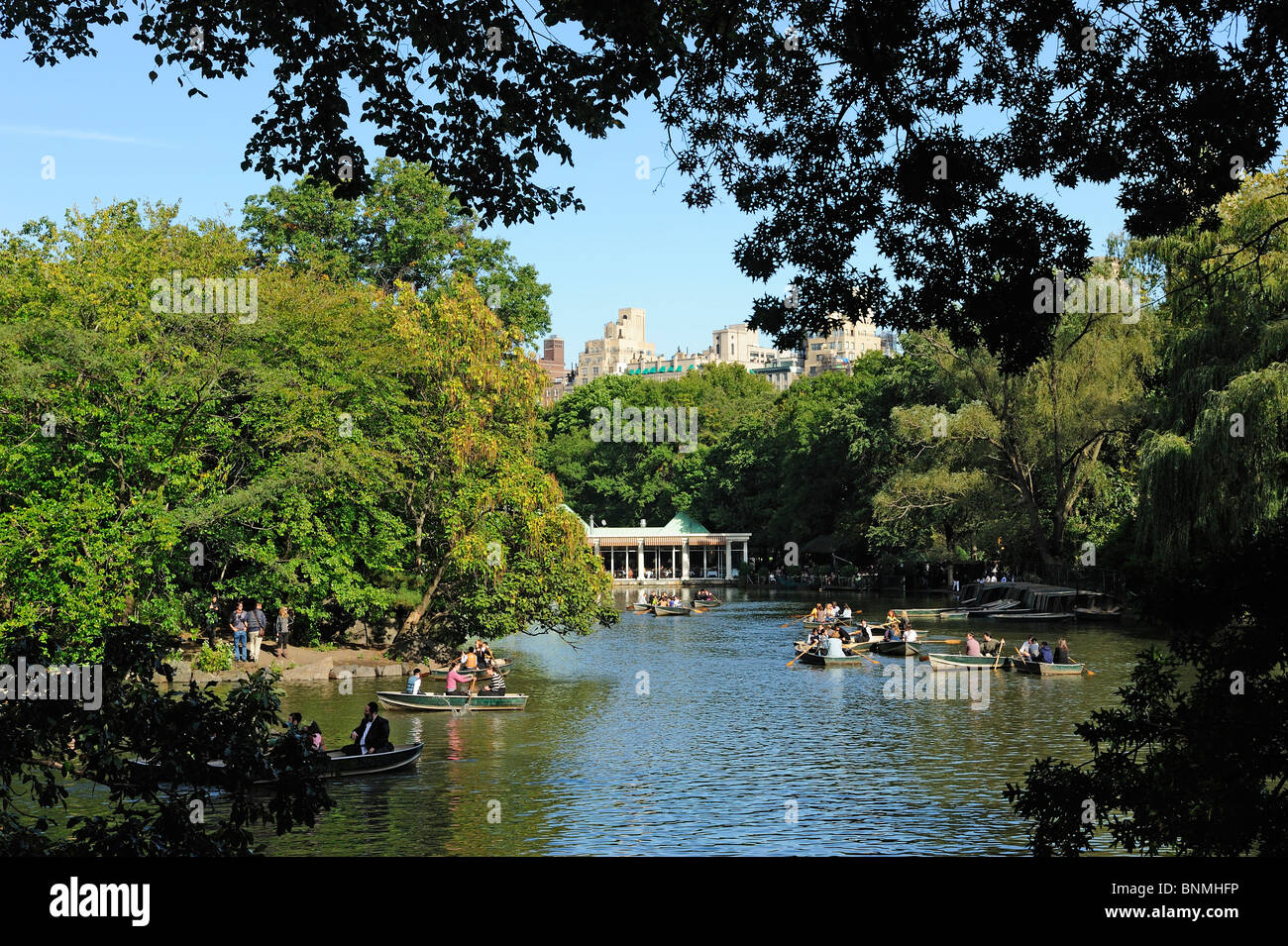 Row Boats Lake Central Park trees buildings New York City City Upper East Side Manhattan New York USA America North America Stock Photo