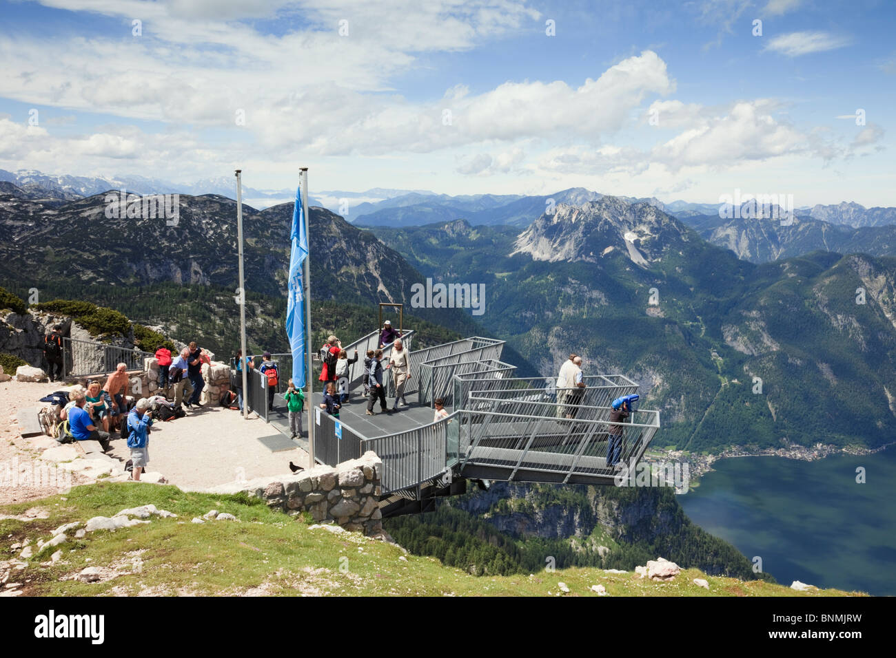 People on 5fingers viewing platform on Krippenstein mountain at Dachstein World Heritage site above Hallstattersee lake in Alps. Stock Photo