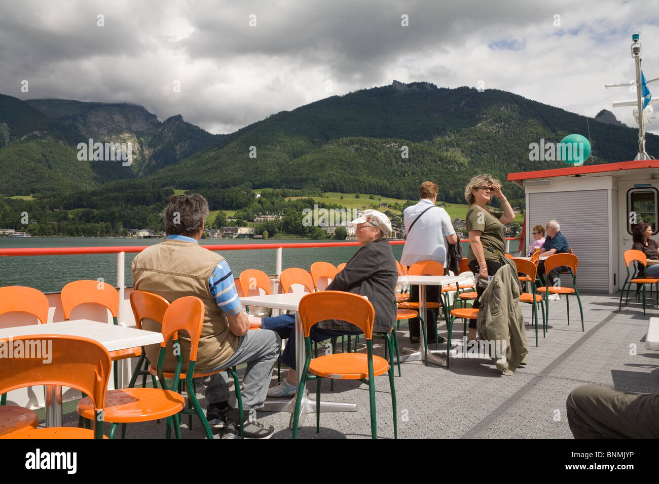 Upper Austria Europe EU Passengers on the upper deck of the ferry crossing the Wolfgangsee to St Wolfgang Stock Photo