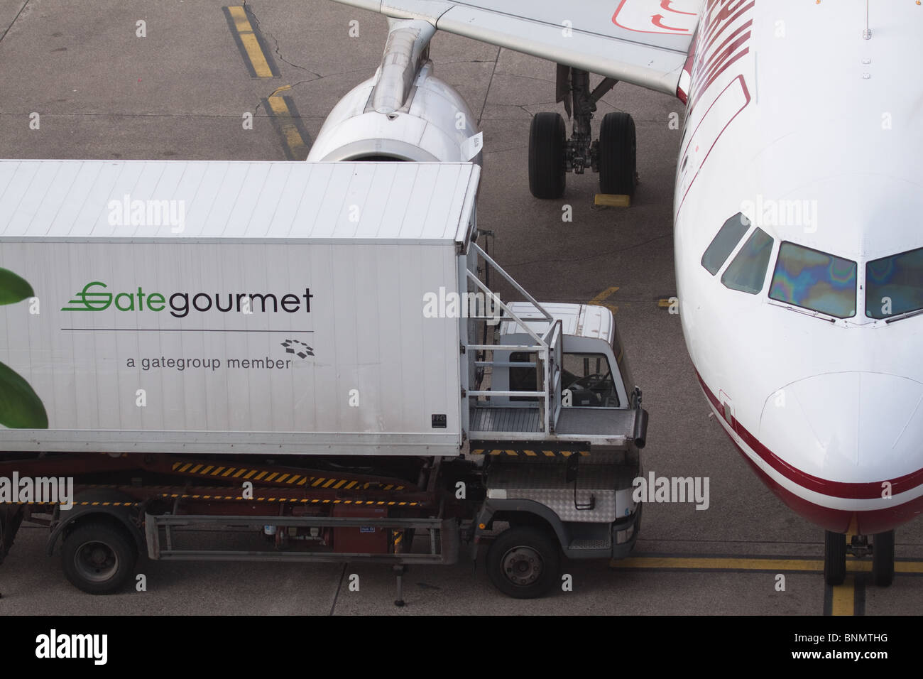 Aeroplane with Gate Gourmet lorry at Dusseldorf International Airport Stock Photo