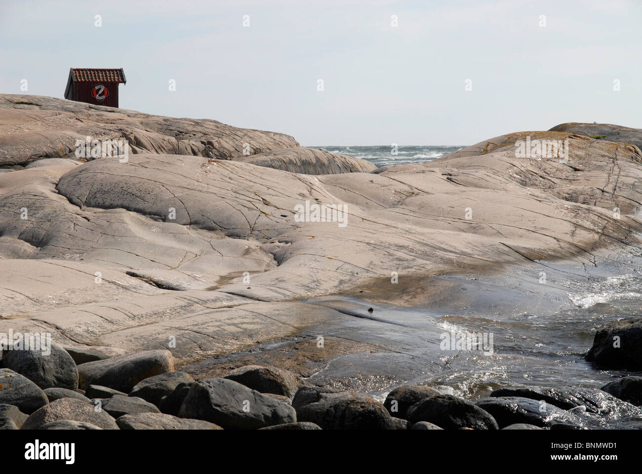 Rocks and a hut at the entrance of the harbour of Tjurpannan, Swedish West Coast Stock Photo