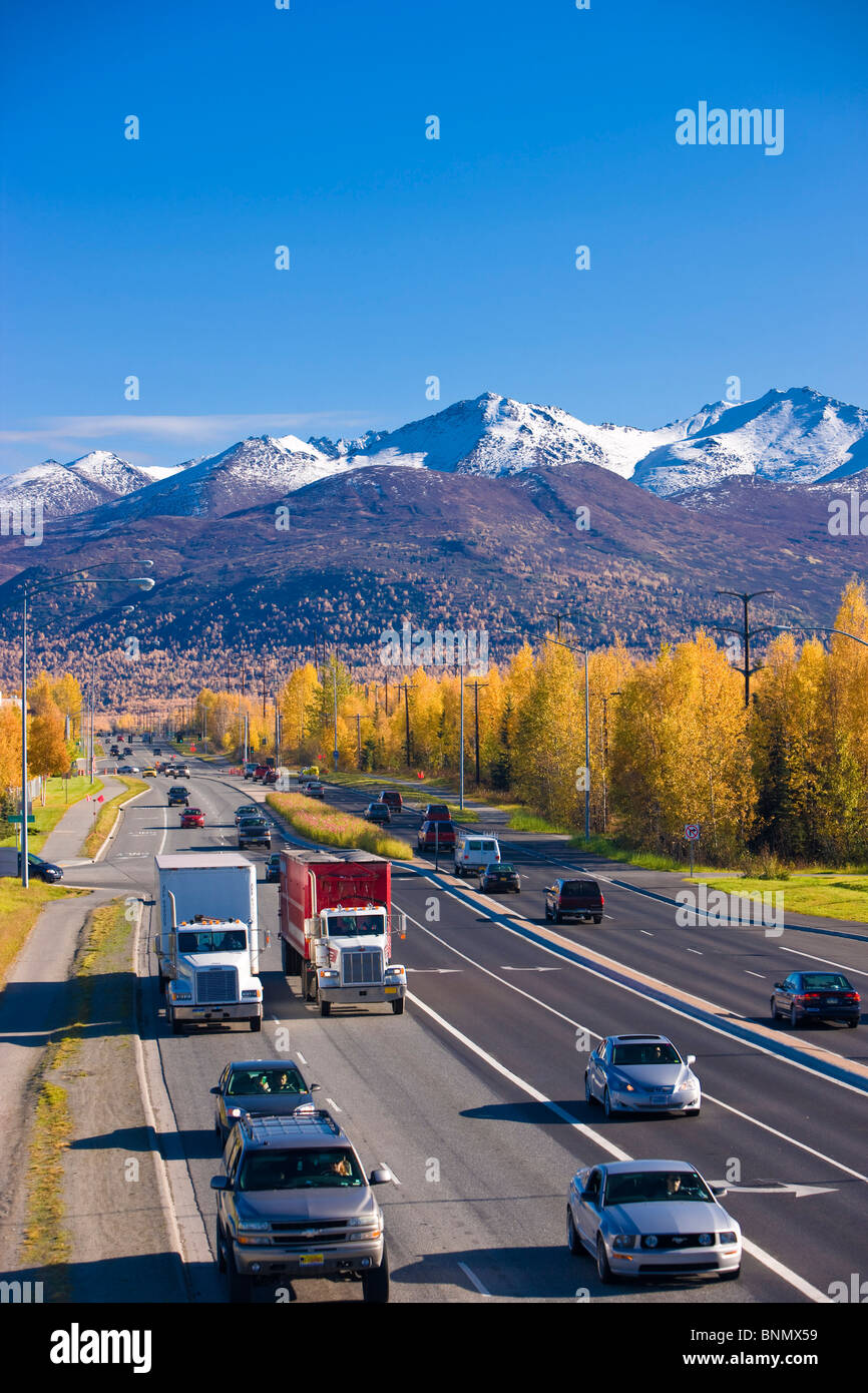 Traffic on Tudor Road looking east towards the Chugach Mountains during Autumn, Anchorage, Alaska Stock Photo