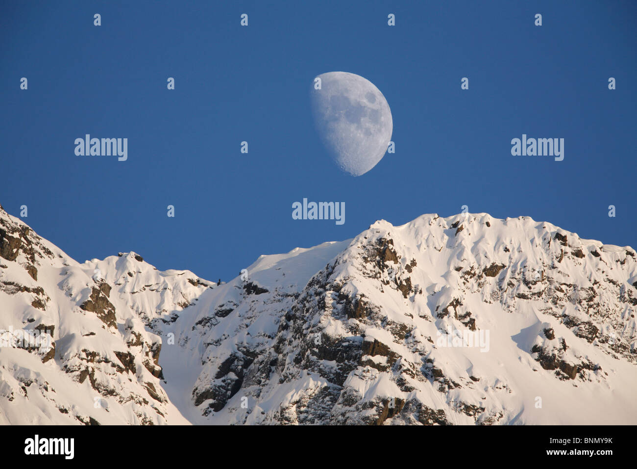 Moon over Pioneer Peak, Chugach Mountains, SC, AK Stock Photo