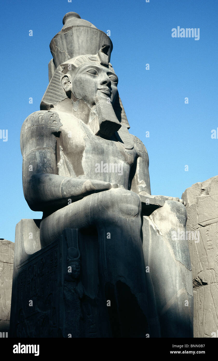 Statue of Ramesses guarding the entrance to the Colonnade at the Court of Ramesses II inside Luxor Temple. Stock Photo