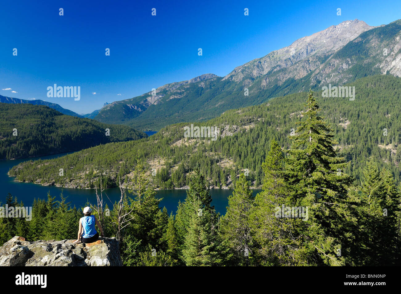 Woman sitting Rock Ross Lake Marblemount North Cascades National Park