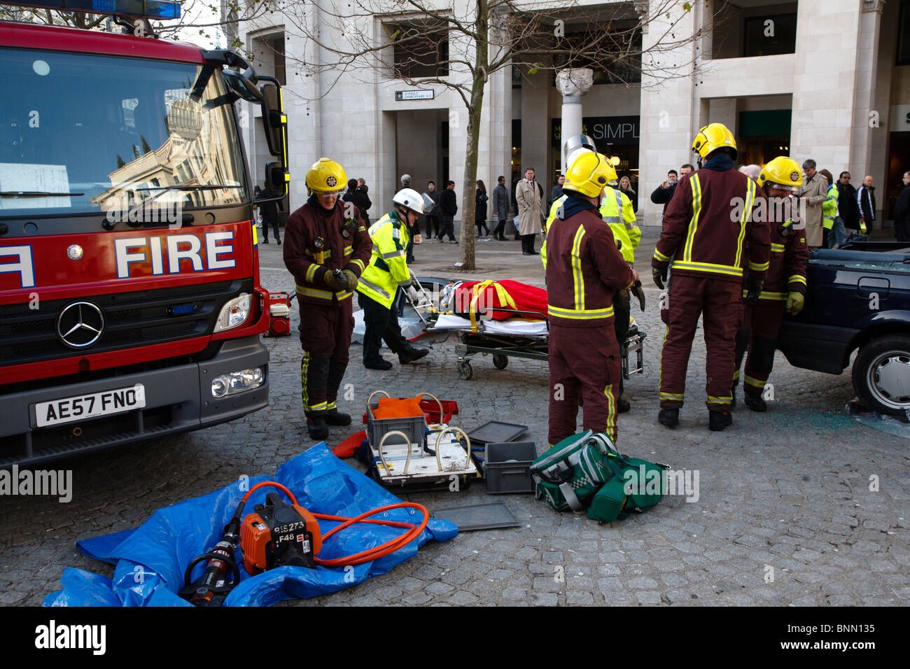 Simulated rescue of car crash victim by firemen and paramedics for taining exercise Stock Photo