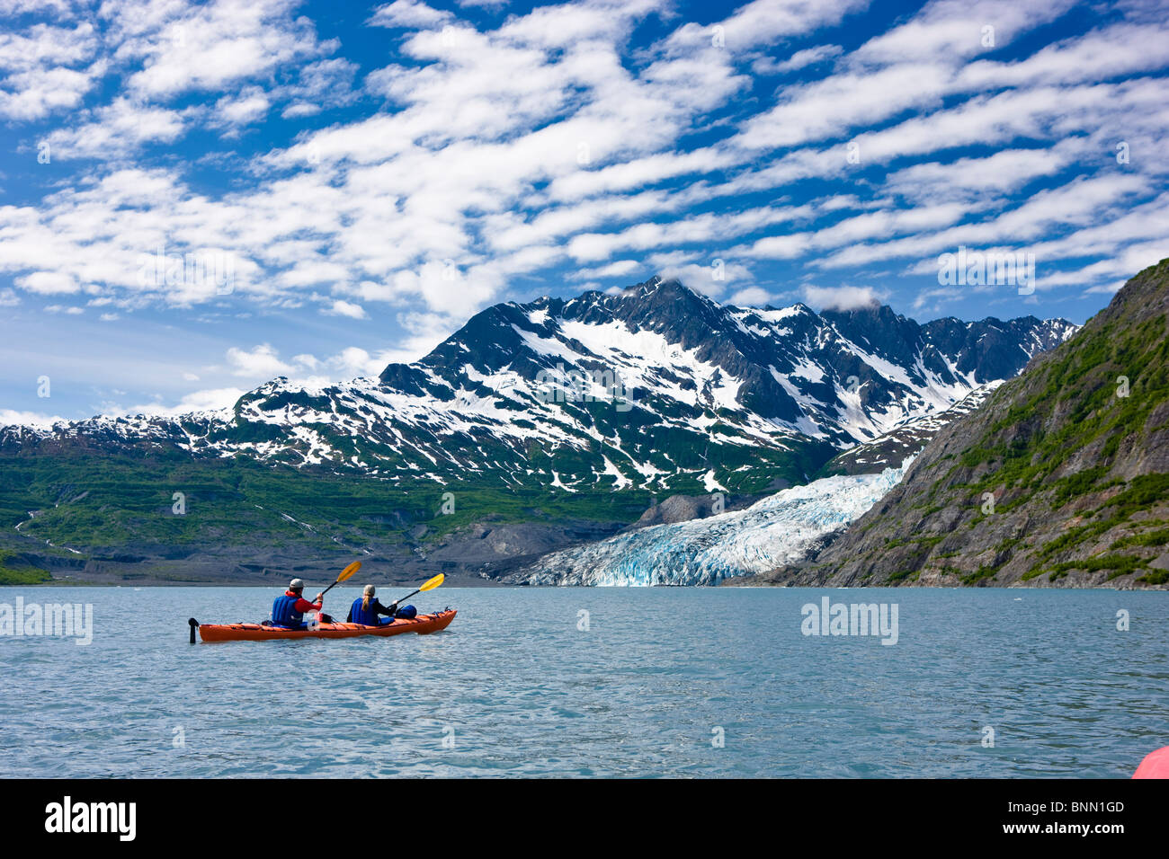 Couple kayaking in Shoup Bay with Shoup Glacier in the background, Prince William Sound, Alaska Stock Photo