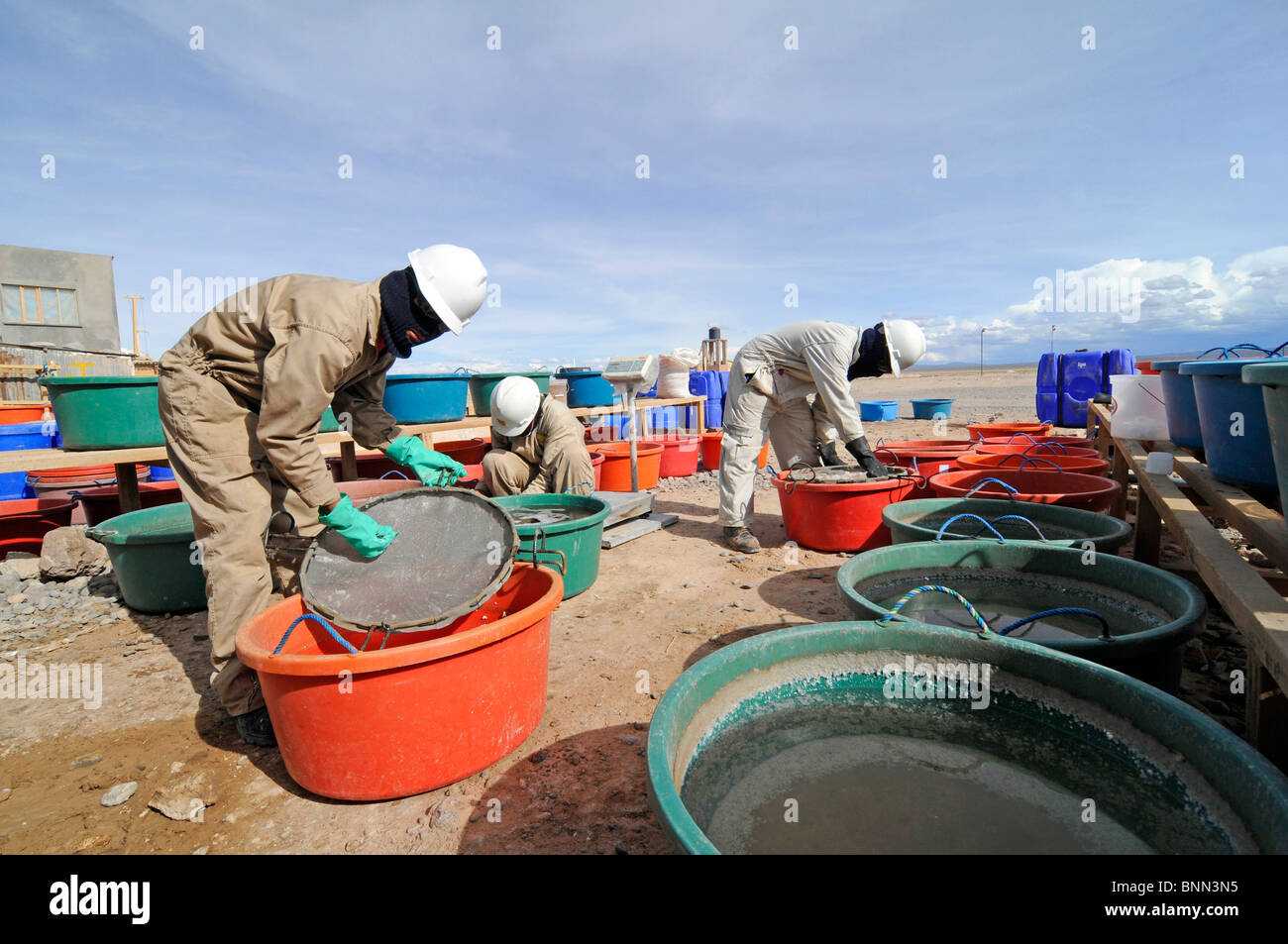 Bolivian workers at a pilot lithium extraction factory in the Salar de