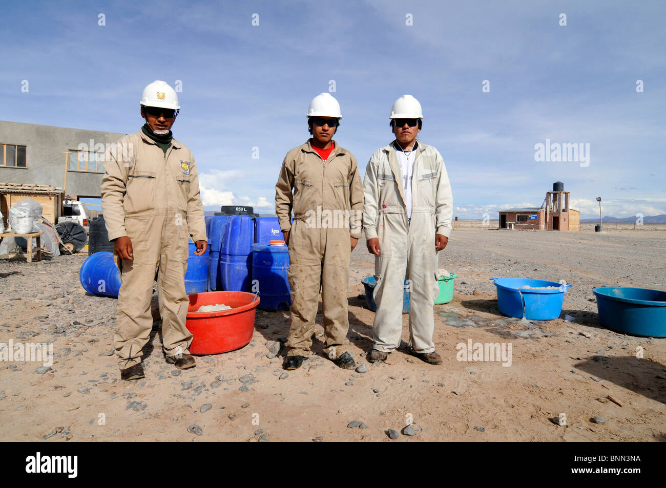 Bolivian workers at a pilot lithium extraction factory in the Salar de Uyuni, the largest salt desert in the World. Stock Photo