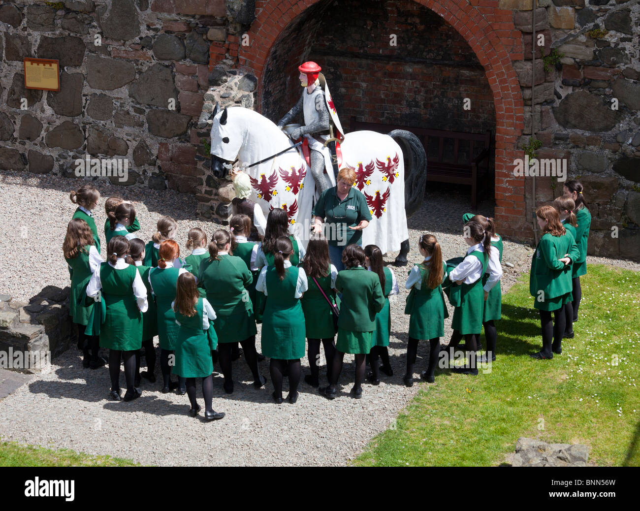 schoolgirls on educational visit to Carrickfergus castle, Northern Ireland, UK Stock Photo