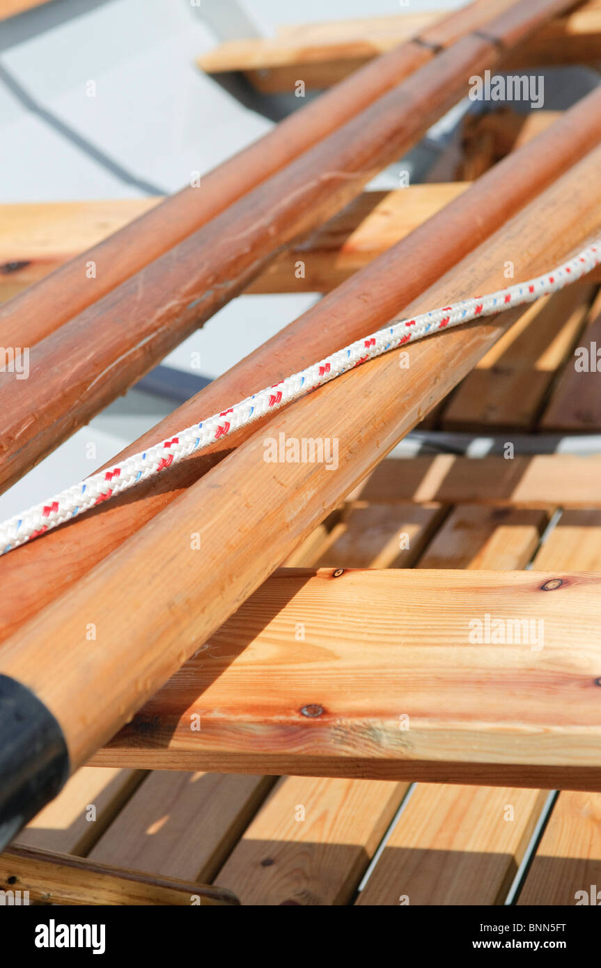 Oars and rope in a wooden rowing boat. Stock Photo