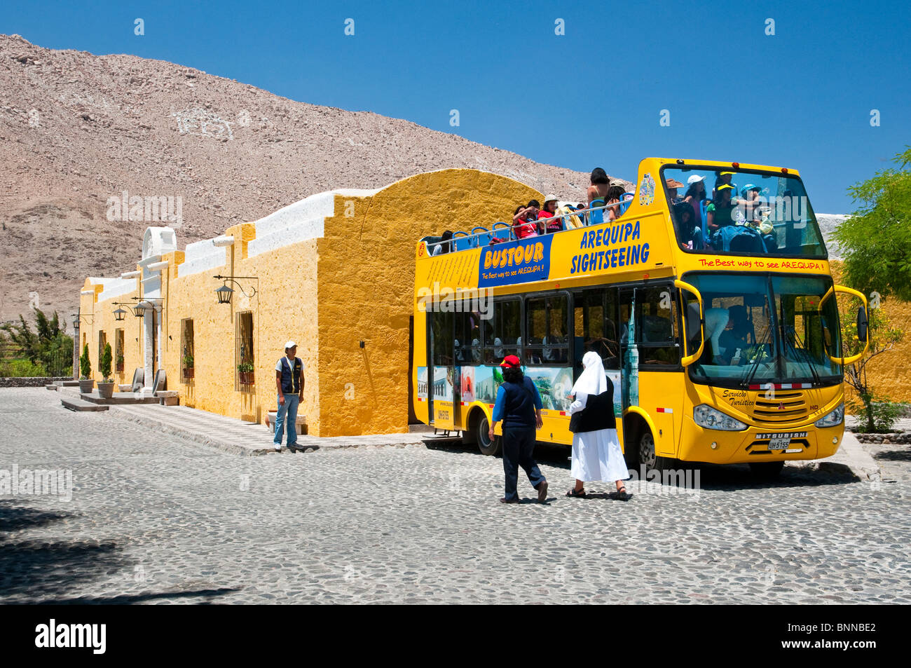 Yellow sightseeing bus at the Fundaor Mansion in Arequipa, Peru. Stock Photo
