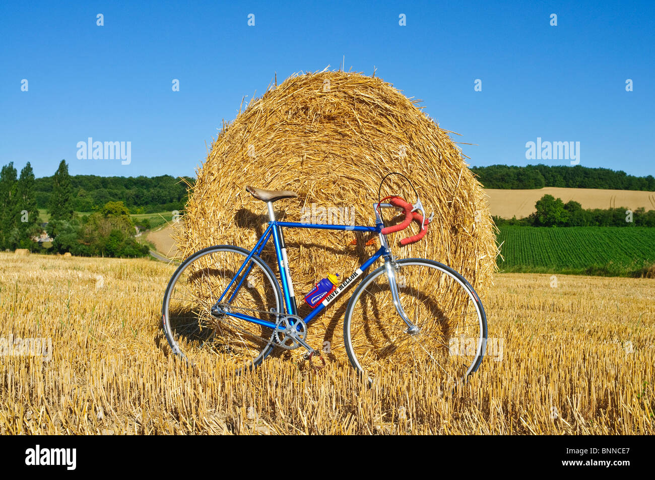 Fixed wheel bicycle in front of round straw bale - Indre-et-Loire, France. Stock Photo