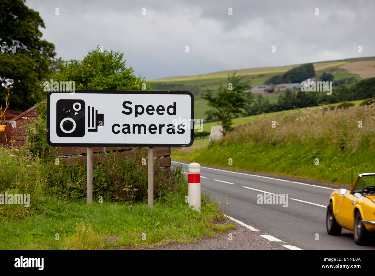 A UK speed camera sign at the side of an A road Stock Photo