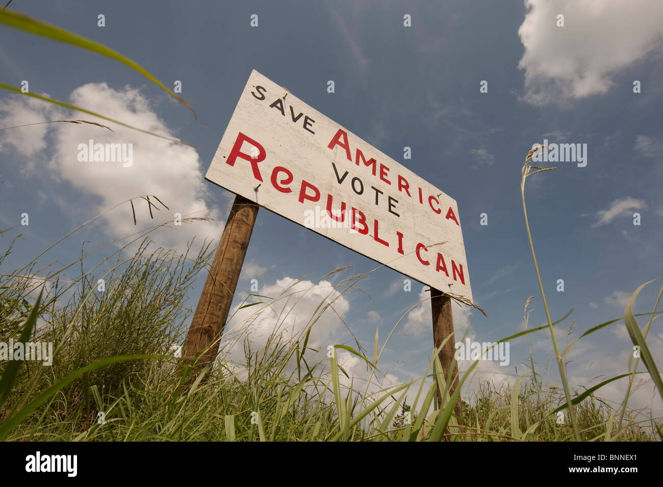 A hand-painted plywood sign urging passers-by to vote Republican stands alongside the highway in Marquez, Leon County in east TX Stock Photo