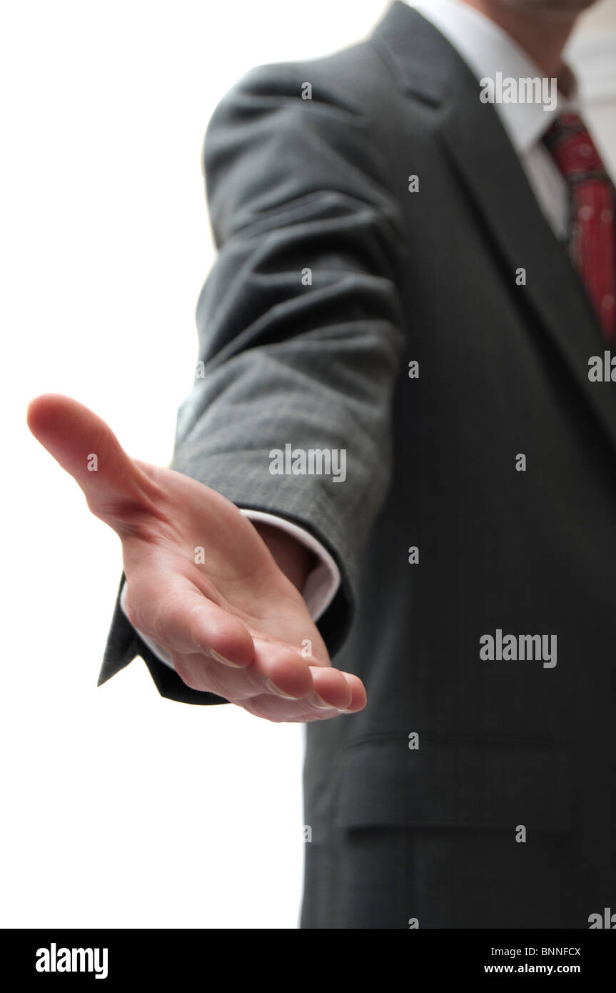 Tall white caucasian business man welcomes you with a pre-handshake isolated on white background with copyspace on left Stock Photo