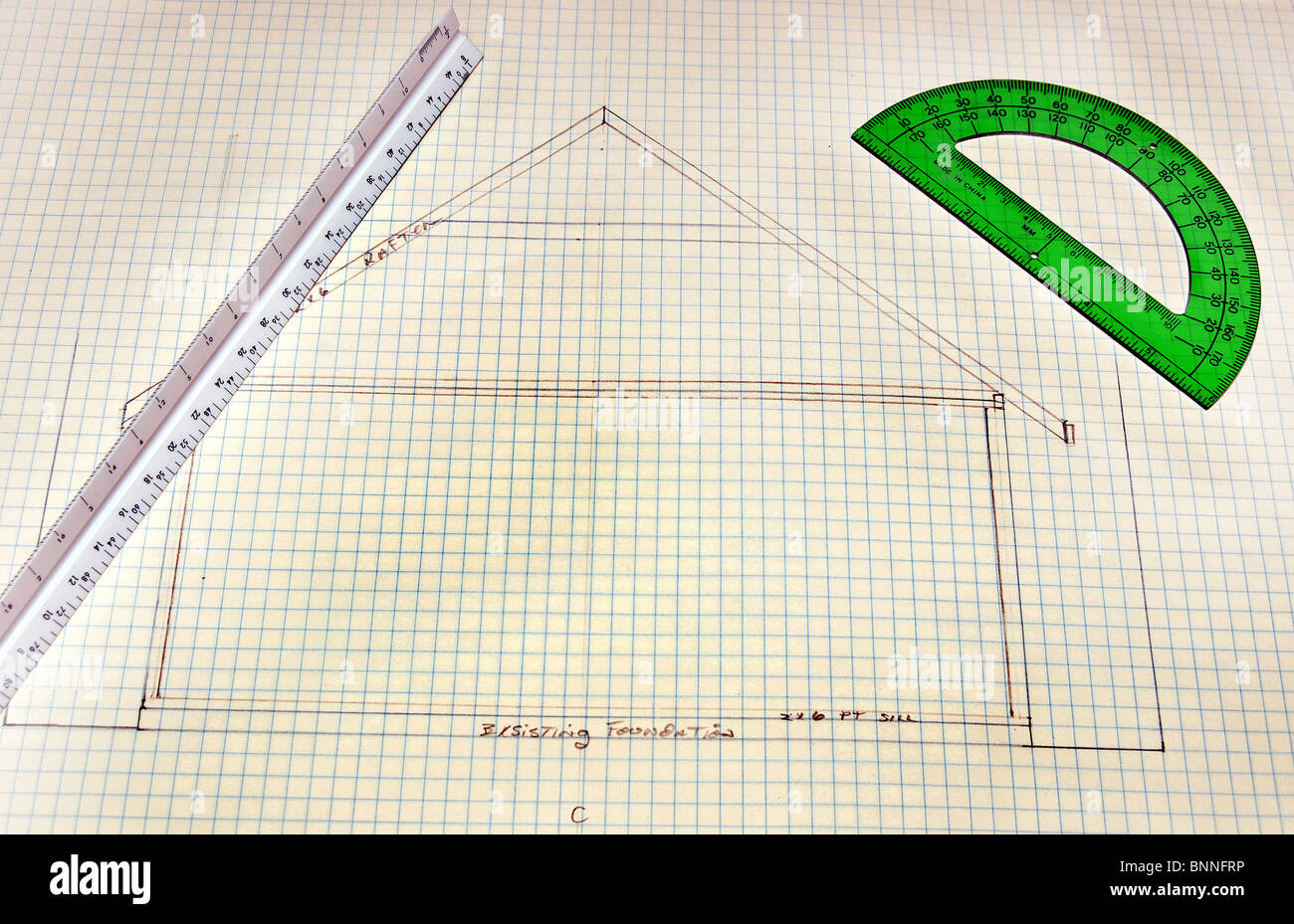 Rough sketch of house Floor Plans on grid paper with green ruler Stock Photo