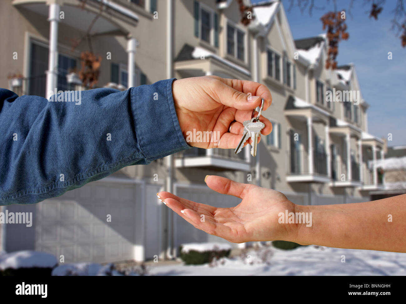 Man's Hand Handing Over the Keys of a New Apartment to a Woman's Hand ...