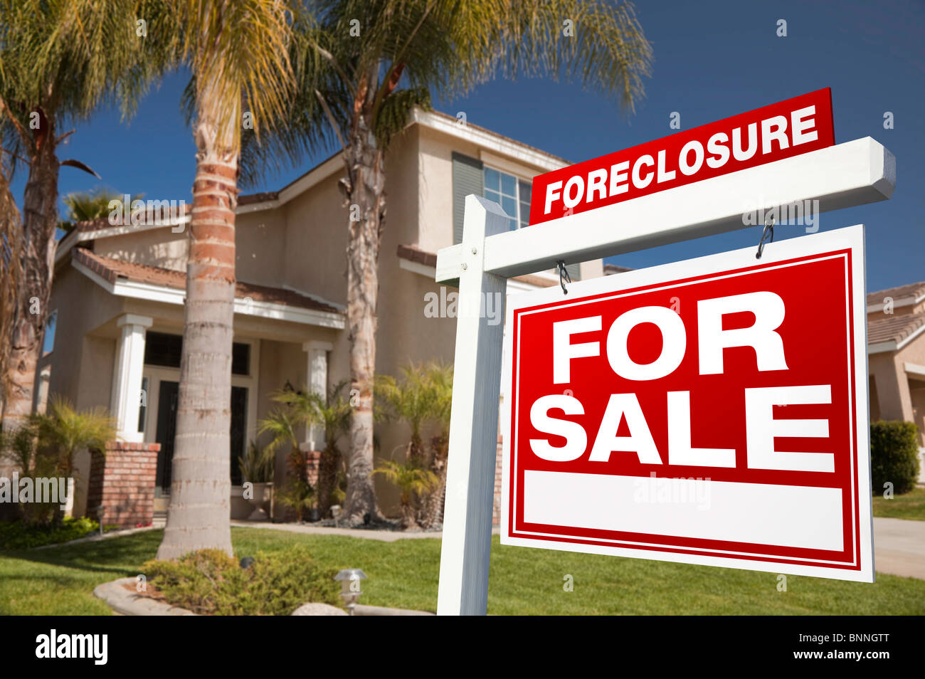 Foreclosure For Sale Real Estate Sign in Front of House. Stock Photo